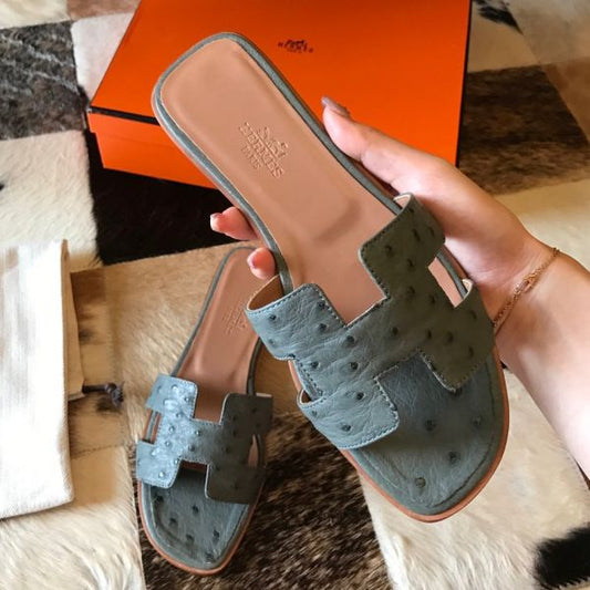 HERM Oran Slide Sandals In Vert Amande Ostrich Leather