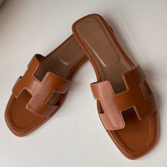 HERM Oran Slide Sandals In Gold Swift Calfskin