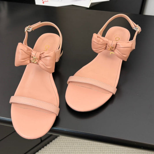 FLAT SANDALS IN PEACHY PINK CALFSKIN WITH BOW